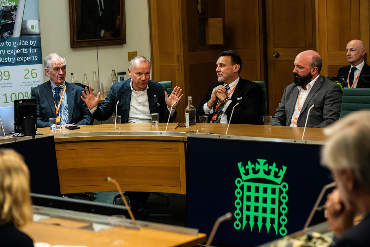 Panel participants taking part in a discussion in a parliamentary committee room