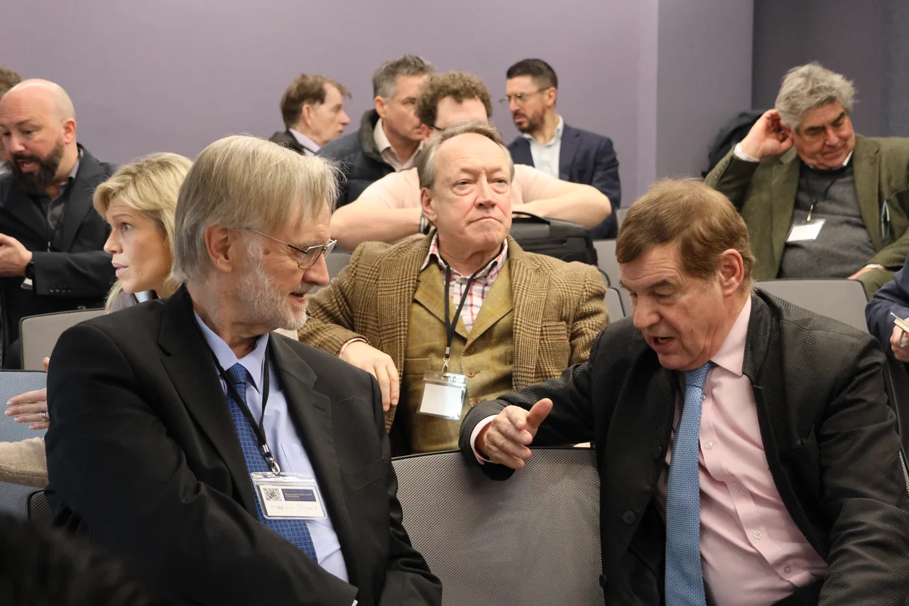 A mixed group gathered around a table for an industry discussion
