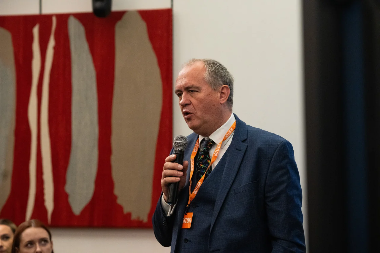 A speaker addressing participants during a parliamentary industry event