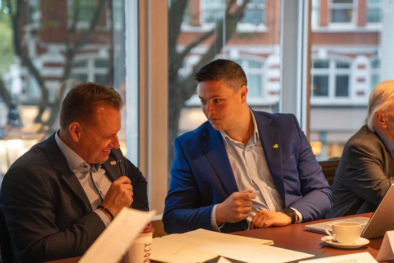 Participants discussing a construction topic at a roundtable table