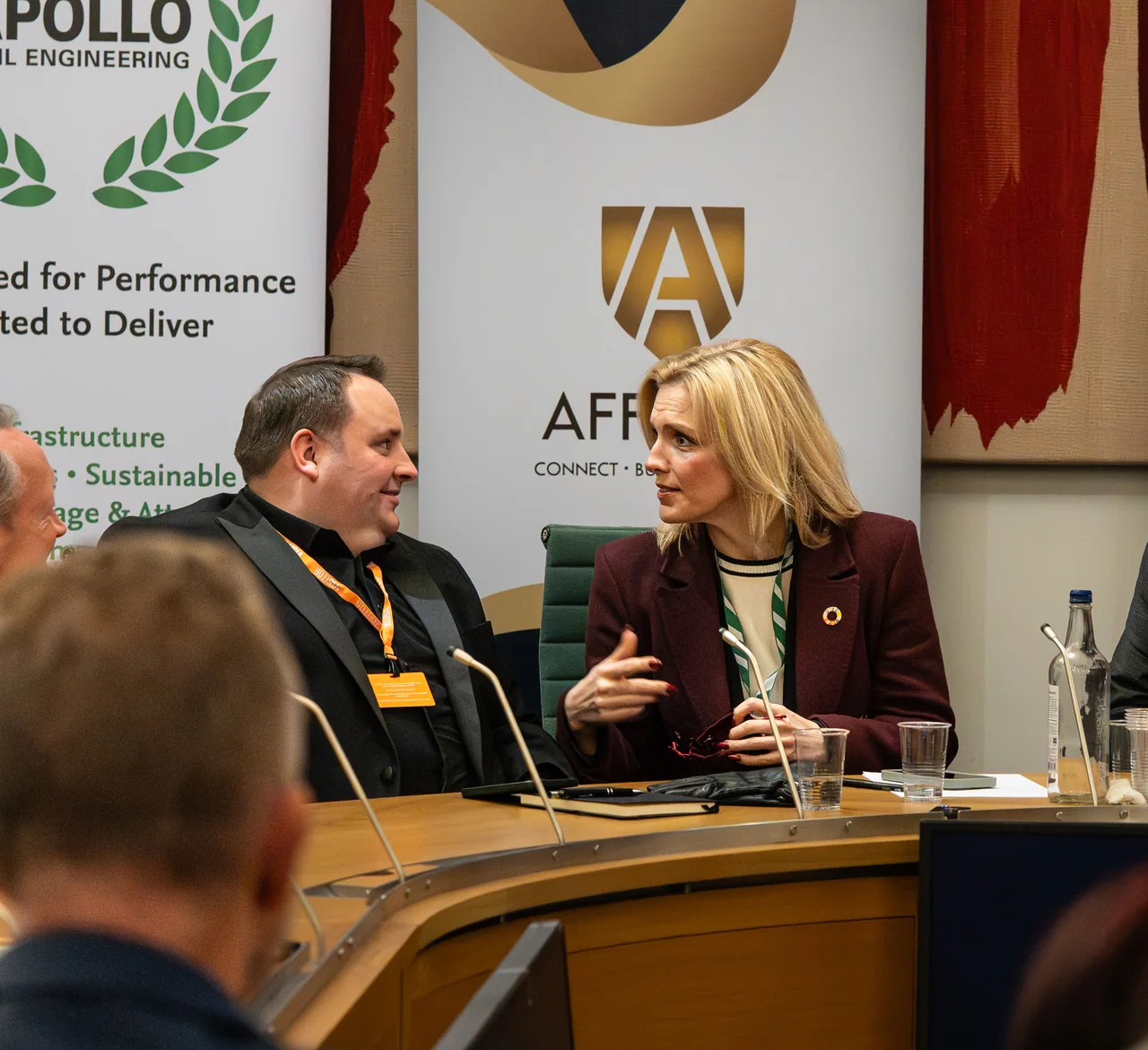 Panel participants exchanging views during a parliamentary committee-room discussion